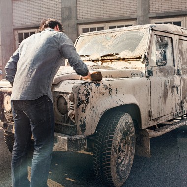 Man cleans a dirty car