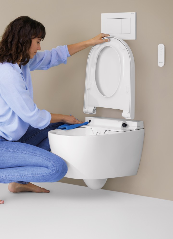 Woman cleans a toilet