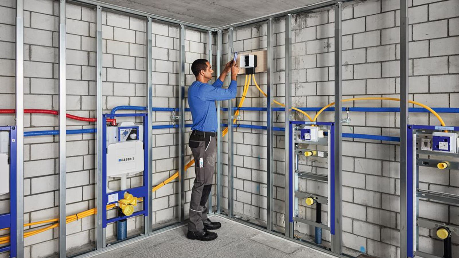 Installation of conduit pipes for cabling and the installation box in the Geberit Duofix system. Installation of conduit pipes for cabling and the installation box in the Geberit Duofix system.